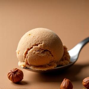 Rich brown hazelnut gelato with scattered hazelnuts