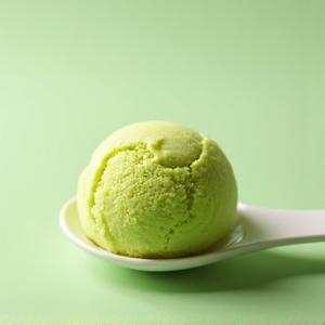 Vibrant green pistachio gelato in a scoop
